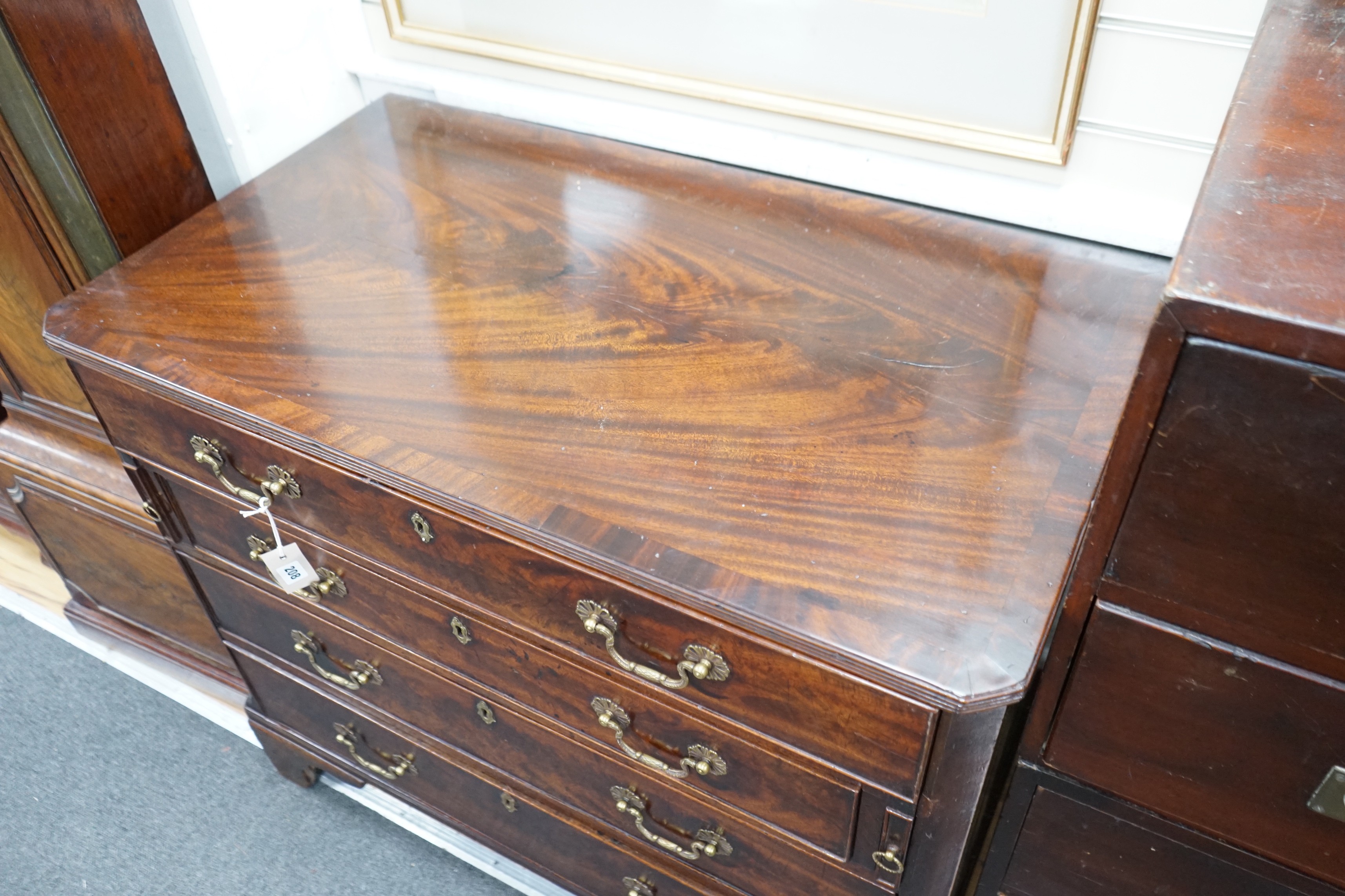 A George III and later mahogany dressing chest, the compartmented top drawer with sliding baize surface, width 98cm, depth 56cm, height 85cm
